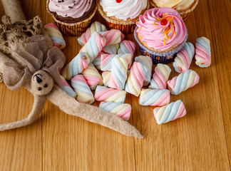 handmade rabbit doll with heap of sweets