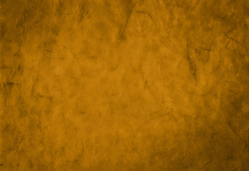 Decorative golden background from organic handmade paper with fiber texture