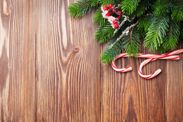 Candy cane and christmas tree on wooden table