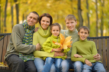 Family relaxing in autumn park