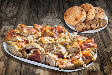 Plateful of Spit Roasted Pork, with Baguette Integral Bread Slices, and Pita Bread Loafs, on Old, Lacquered, Peeled-off, Varnished, Wooden Garden Table Surface.