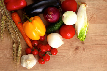 Composition with assorted raw organic vegetables wooden table