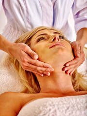 Obraz na płótnie Canvas Woman middle-aged take face massage in spa salon.