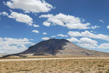 Lonely mount shadowed by clouds