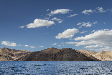 Rippled surface of high altitude mountain lake among sand and rock hills