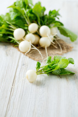 white radishes on wooden surface
