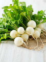 white radishes on wooden surface