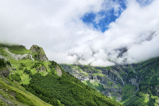 Scenic summer landscape of green mountains and glacier waterfalls