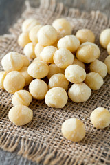 salted macadamia nuts on wooden surface