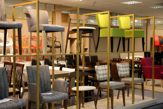 Colored stools and chairs in furniture store 