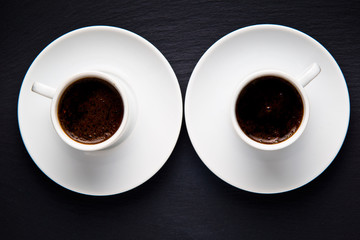 Cups of coffee over the black background