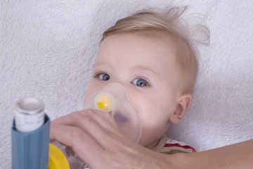 Infant with asthma inhalator