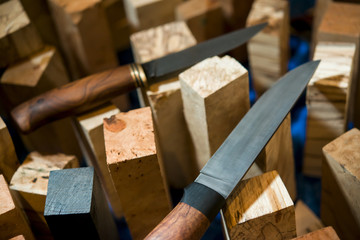 Master manufactures knives. Hunting knife and wooden beads blank to knife handles