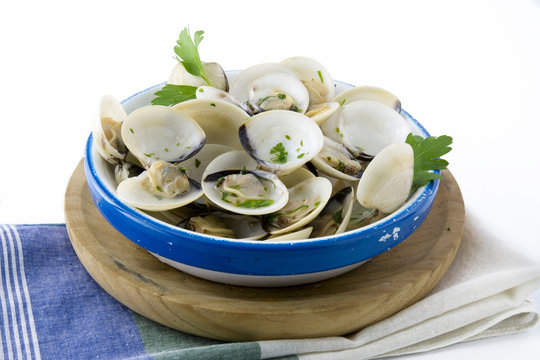 Open clams with parsley on blue napkin, isolated background