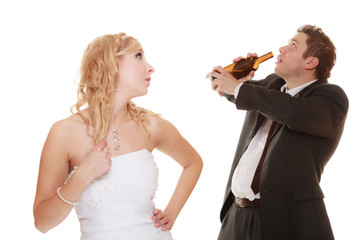 Wedding couple, bride with alcoholic drinking groom.