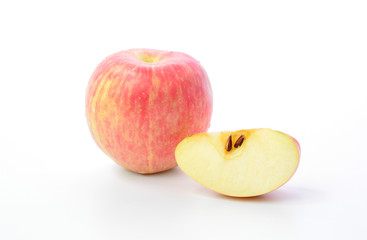 Red apple and slice on a white background