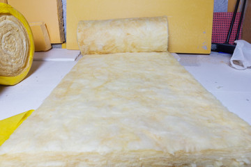 rolled out thermal insulation role in yellow package at attic ba