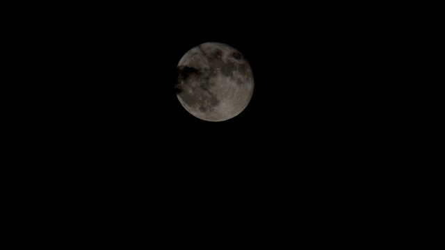 Blue Moon rising above the dark clouds filmed in Utah USA sep 29 