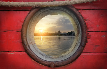 Sunset through a porthole of a boat