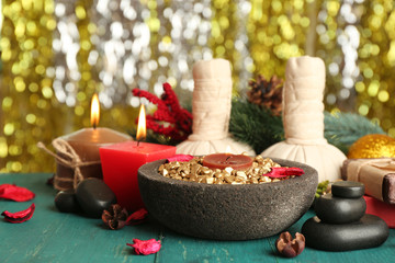 Beautiful Christmas presents composition on green wooden table against sparkle background, close up