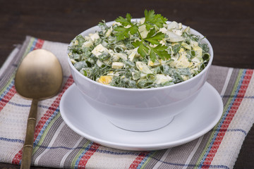 Salad of onions along with the egg and cucumber in white plate