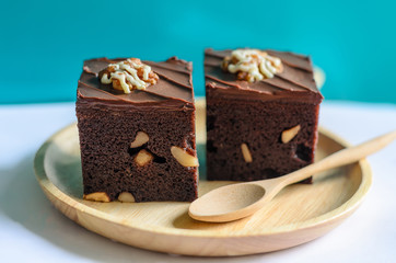 Brownies on wooden plate with green blackground
