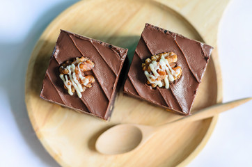 Chocolate Almond Brownies on wooden plate and spoon