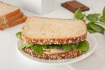 sandwich with mayonaisse, turkey, cheese and fresh spinach