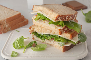 sandwich with mayonaisse, turkey, cheese and fresh spinach