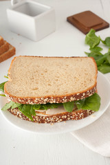 sandwich with mayonaisse, turkey, cheese and fresh spinach