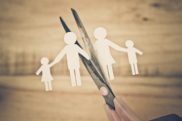 Scissors cutting paper cut of family / Broken family concept / divorce