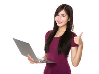 Asian Woman use of the notebook computer and thumb up