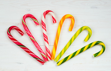 Christmas candy cane on a white wooden background