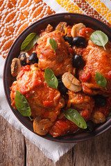 Italian Cacciatori chicken closeup on a plate . vertical top view
