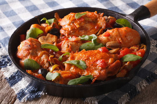 Chicken with tomatoes and vegetables closeup in a pan. horizontal
