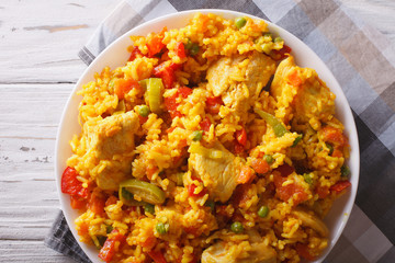 Arroz con pollo close up in a bowl. Horizontal top view
