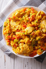 Arroz con pollo close up in a bowl. vertical top view
