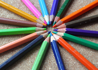 Naklejka premium Colored Old Pencils or Crayons on wood background