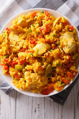 Rice with chicken and vegetables close up in a bowl. vertical top view

