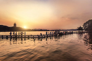 Fototapeta na wymiar beautiful hangzhou in sunset, ancient pavilion silhouette on the
