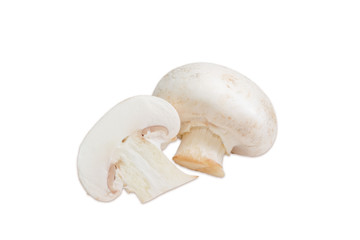 Fototapeta na wymiar One whole and one half of champignon mushroom