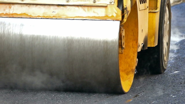 Road roller doing road repair and paving of streets, Slow Motion Video clip