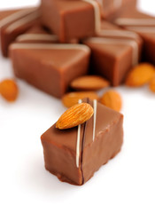 Chocolate praline with almonds on white background