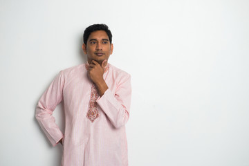 traditional indian male thinking with plain background and copys