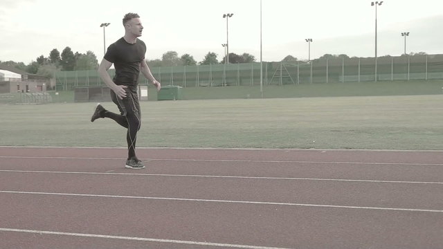 portrait of the man running on the running track in slow motion sprinter 