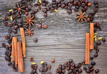 Close-up of cinnamon, anise and coffee beans on a rustic wooden