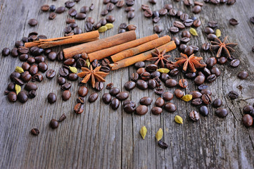 Close-up of cinnamon, anise and coffee beans on a rustic wooden
