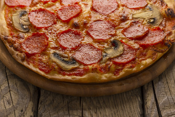 Delicious pizza served on wooden table