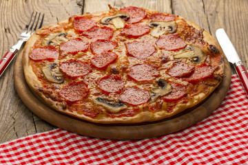 Delicious pizza served on wooden table