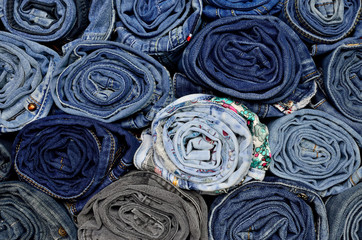 Background of a stack rolled jeans 